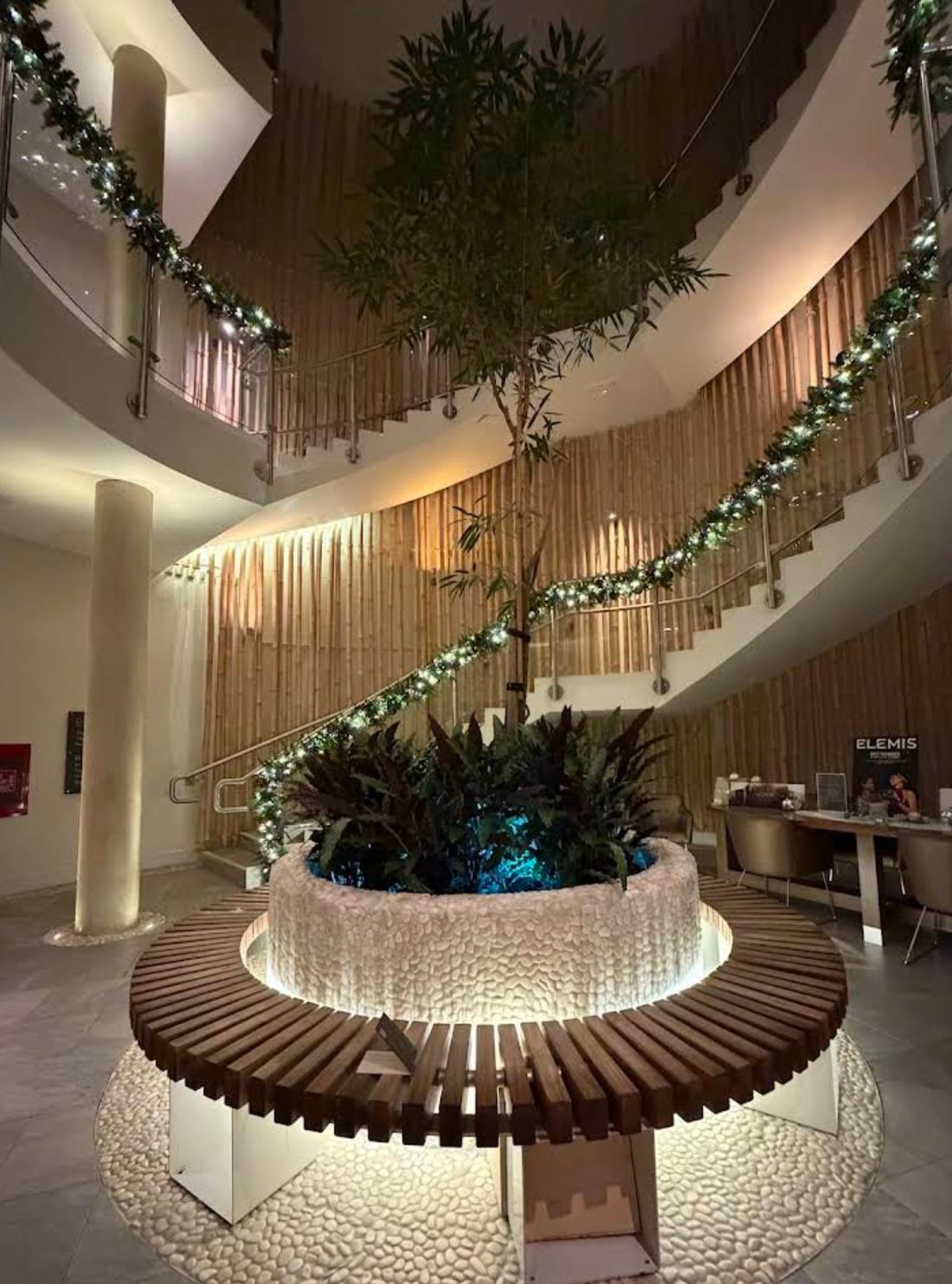 Aqua Sana atrium with spiral staircase and central tree feature
